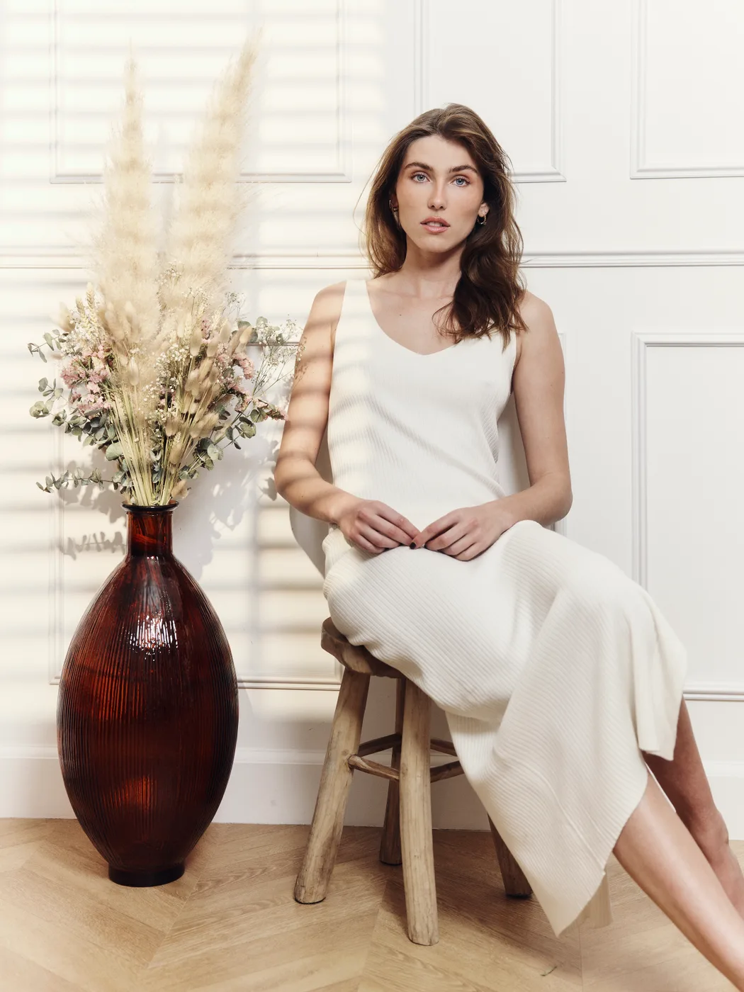 Model in a dress in the Haussmann living room of Le Studio Honoré, natural light